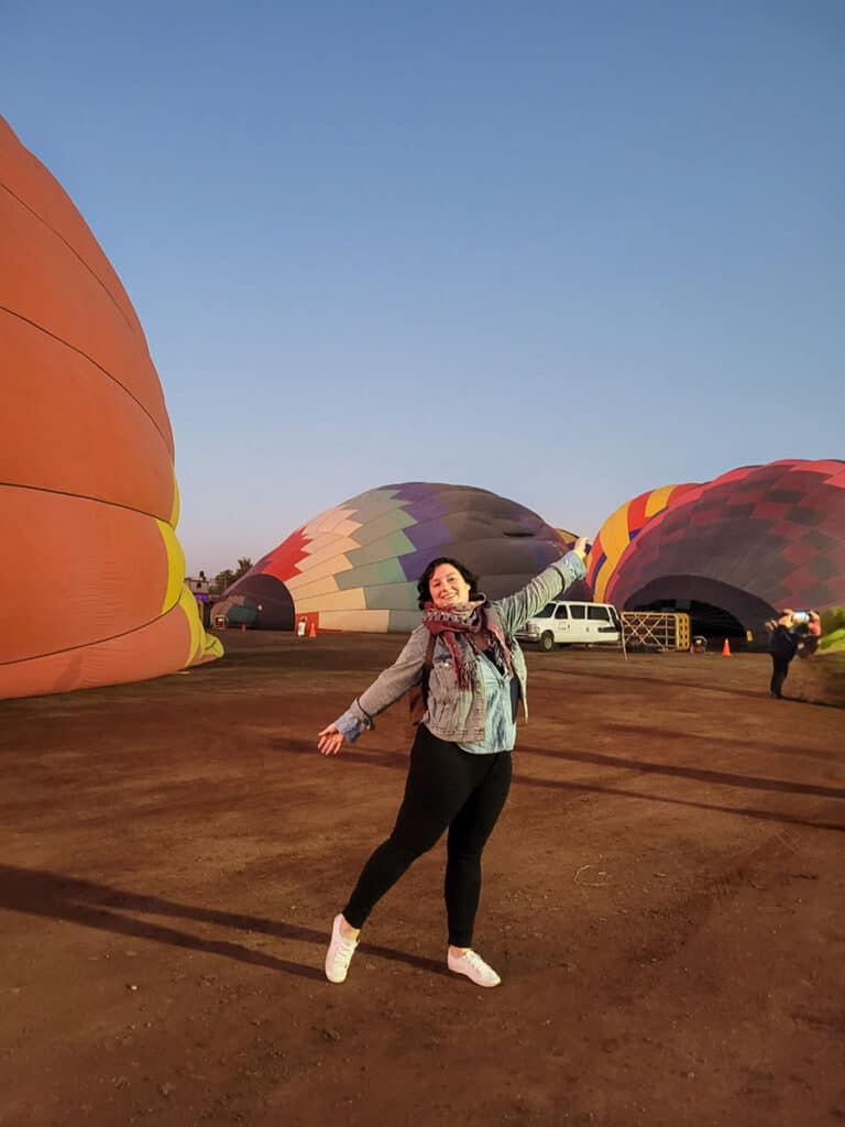 Ashlea standing in front of the hot air balloons being inflated at Teotihuacan.