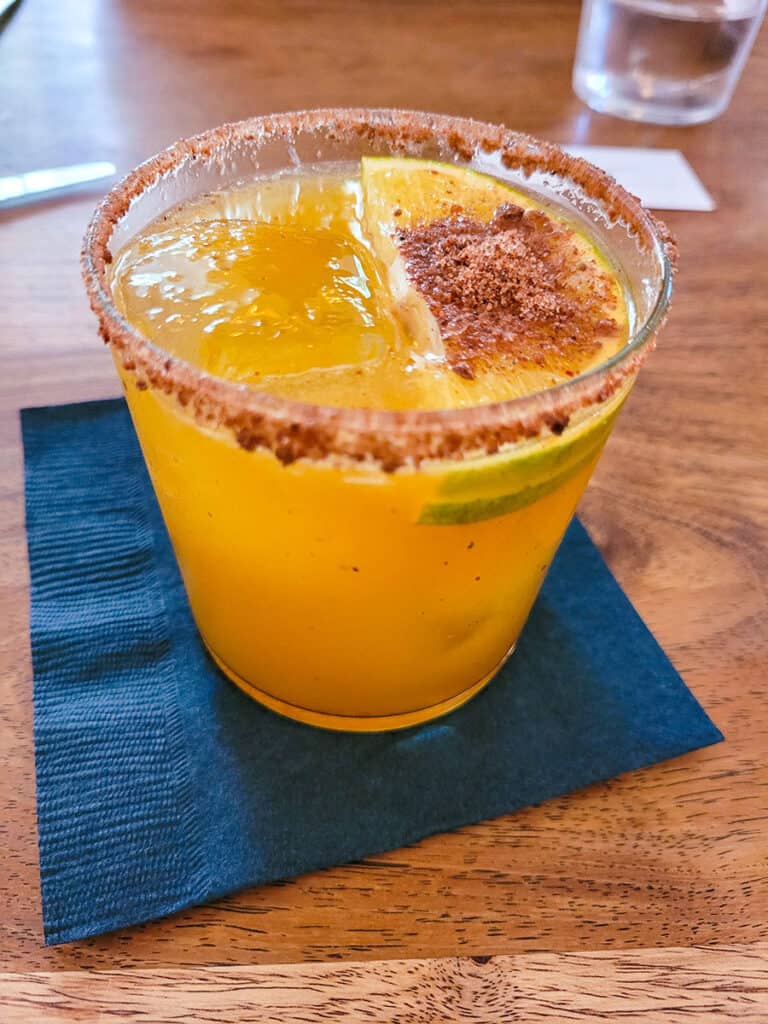 The Mezcalito Tropical signature cocktail at Blanco Colima served with a chapulin salt rim.