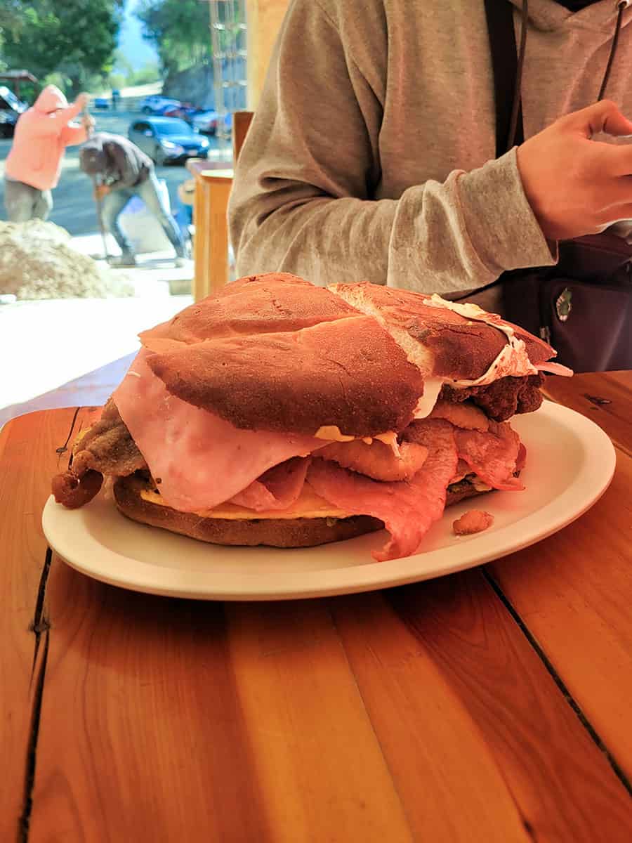 A large torta sandwich the size of a dinner plate served at the restaurant at Grutas Tolantongo.