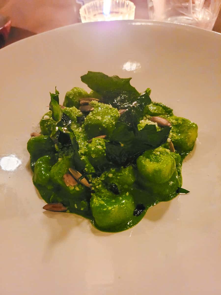 A bright green mount of gnocchi on a white dish at Rosetta Mexico City.