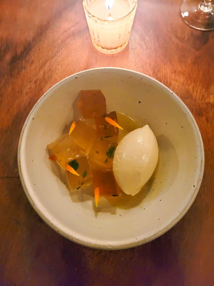 Honey jelly with brown butter vanilla ice cream in a white bowl at Rosetta Mexico City.