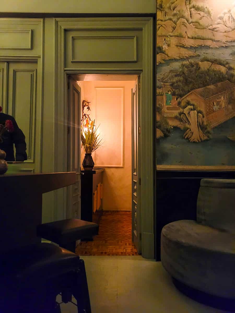 A view of a doorway with art and decor surrounding it at Restaurante Rosetta Mexico City.