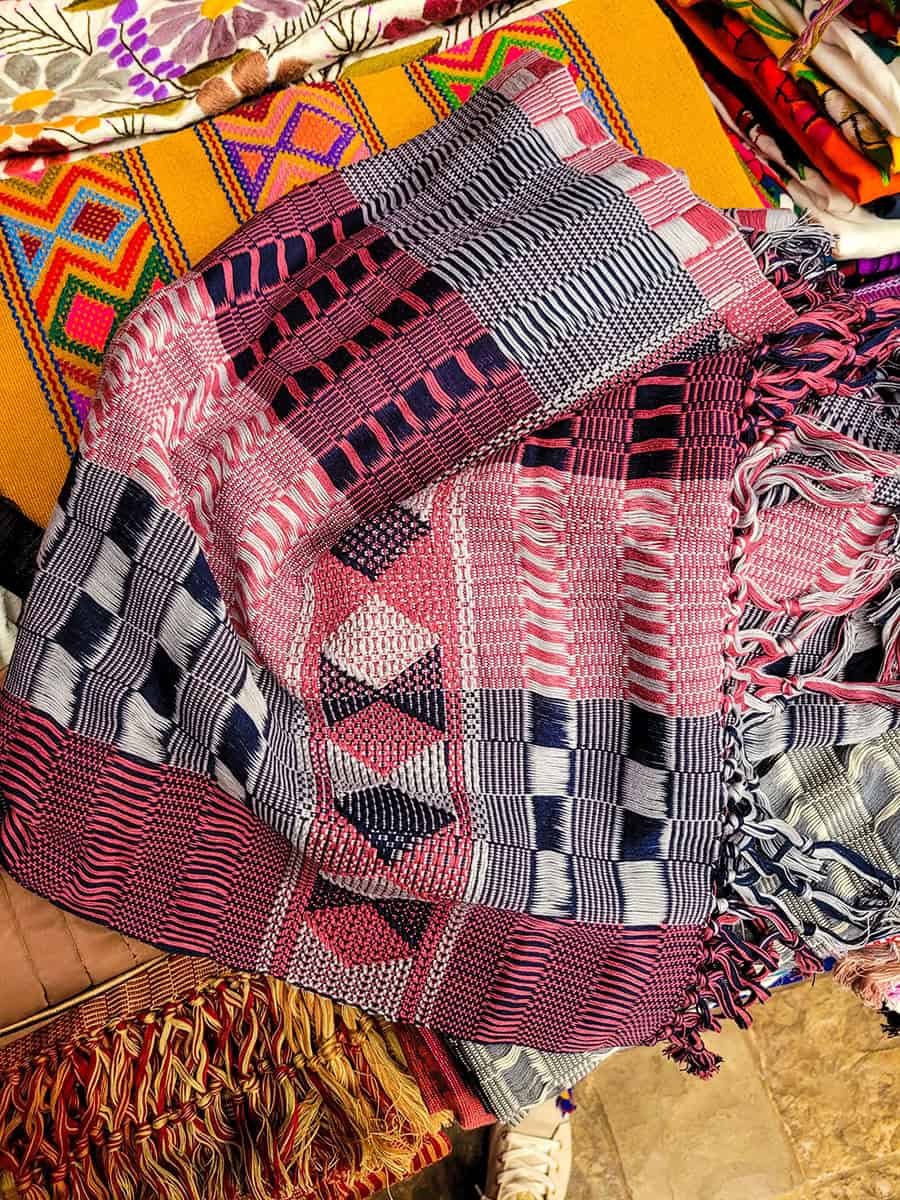 A pink, white and navy handwoven scarf at a market stall in San Cristobal de las Casas, Chiapas.